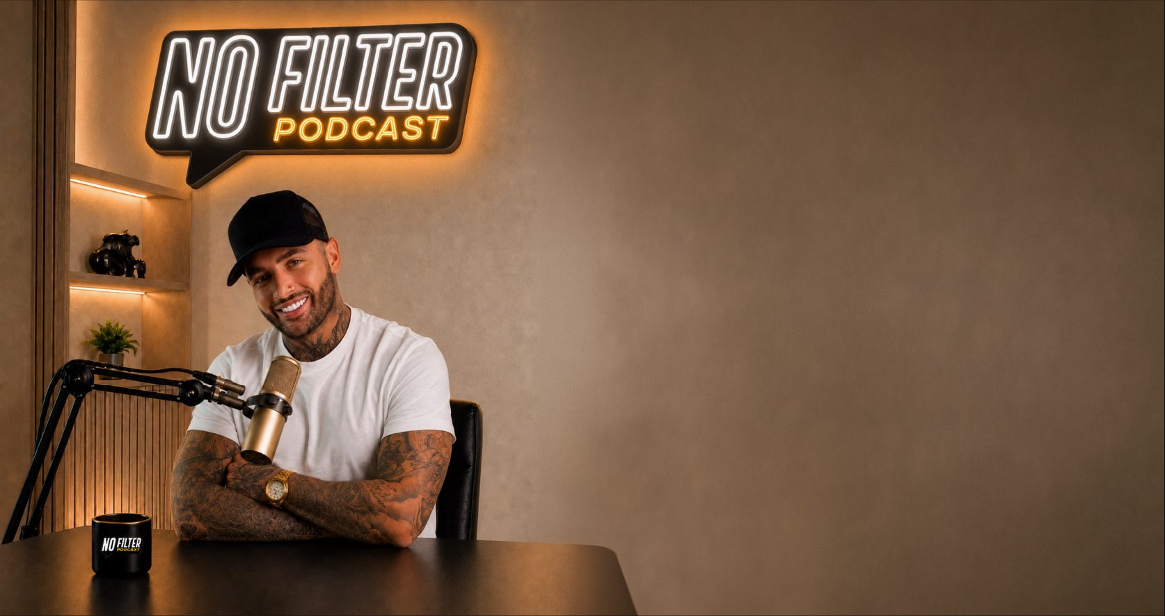Jimmy Bennett at the microphone beneath the No Filter Podcast neon sign