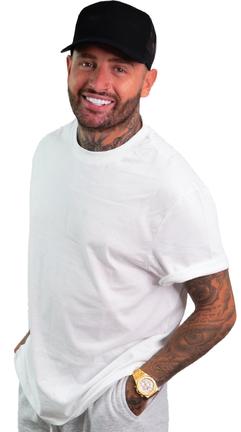 Jimmy Bennett smiling in a white shirt and black cap
